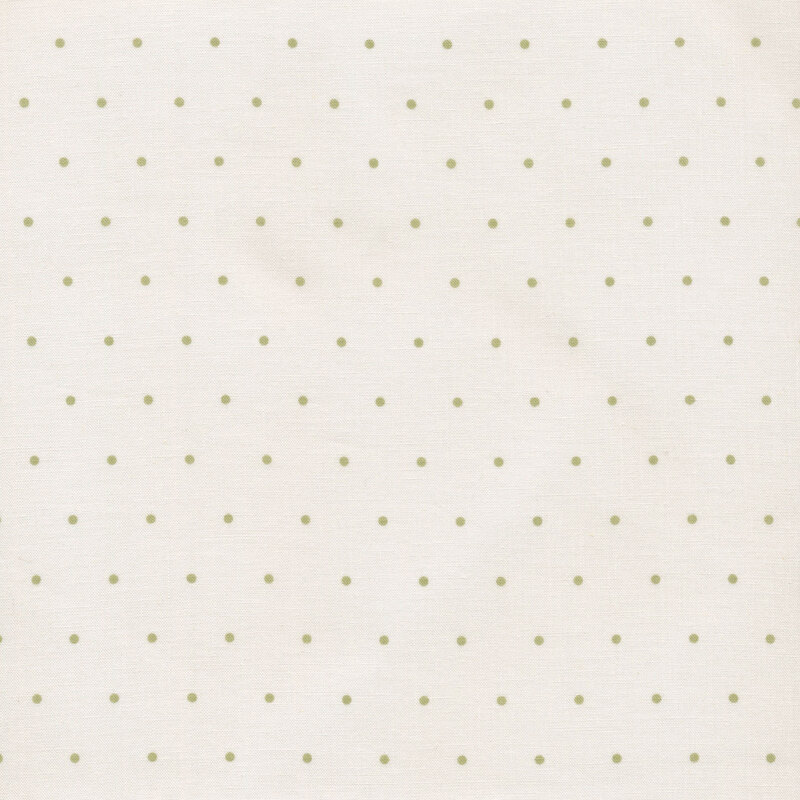 Image of fabric featuring green polka dots on a cream background