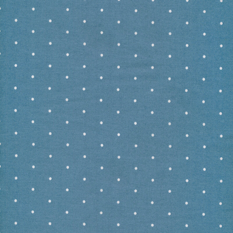 Image of fabric featuring cream polka dots on a blue background