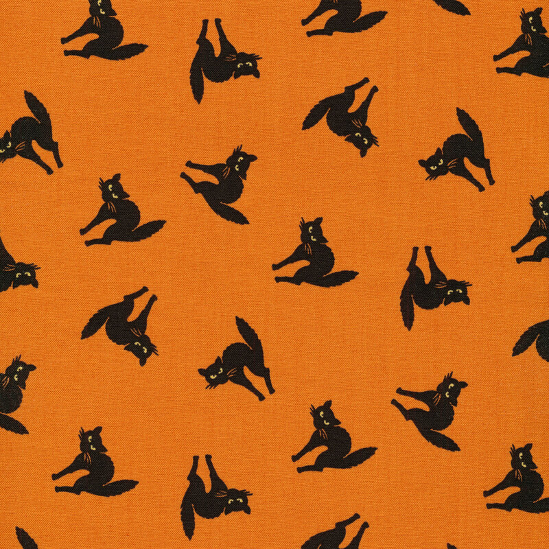 Bright orange fabric with black cats scattered across it