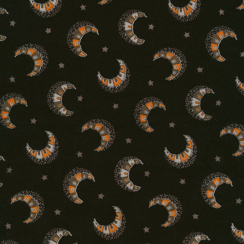 black fabric with mosaic-like crescent moons in orange and grey scattered across it with small stars in between