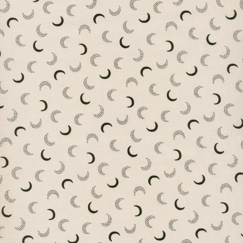 Cream fabric with crescent moons made up of spots and solid black tossed all over
