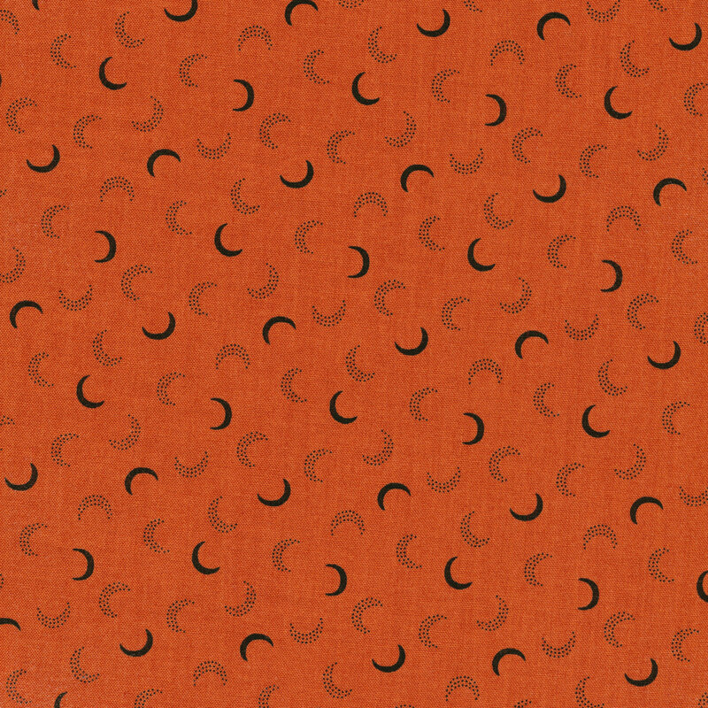 Bright orange fabric with black and spotted moons scattered across it