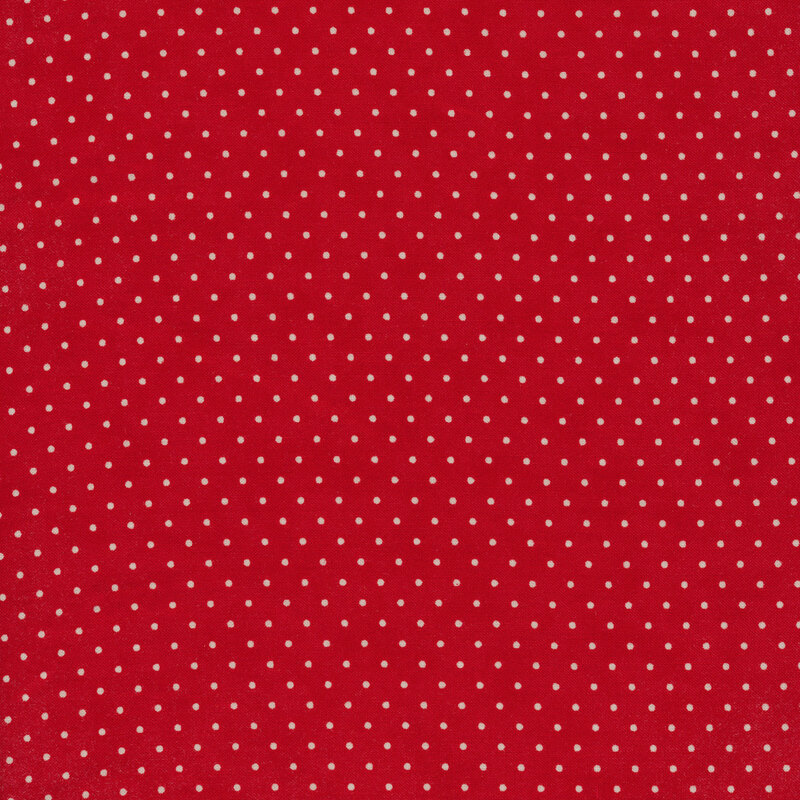 This Moda fabric features a vibrant red background with off white polka dots