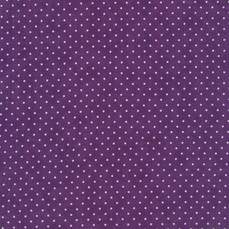 This Moda fabric features a purple background with off white polka dots