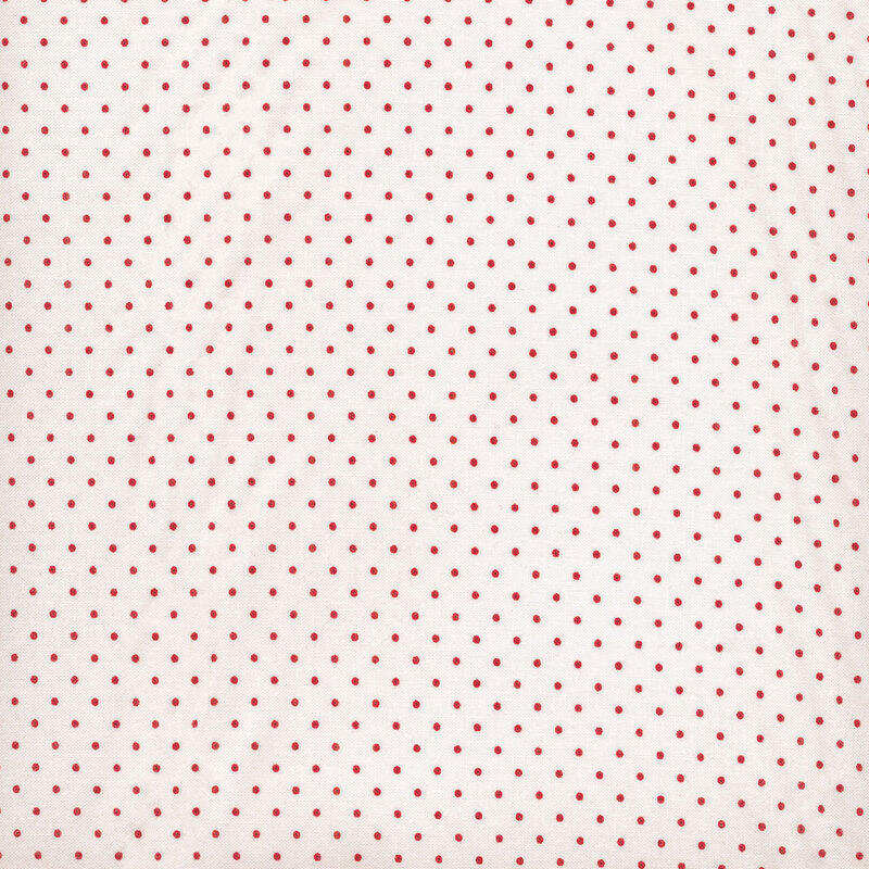 This Moda fabric features an off white background with red polka dots