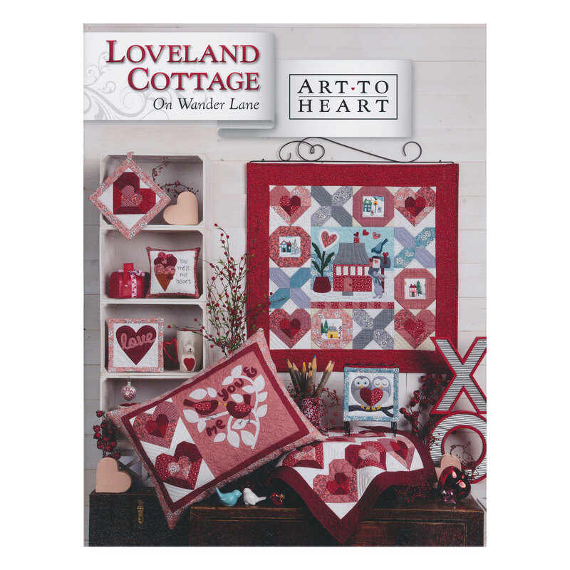 Scan of the front of the Loveland Cottage block pattern book, showing the finished quilt and additional finished projects