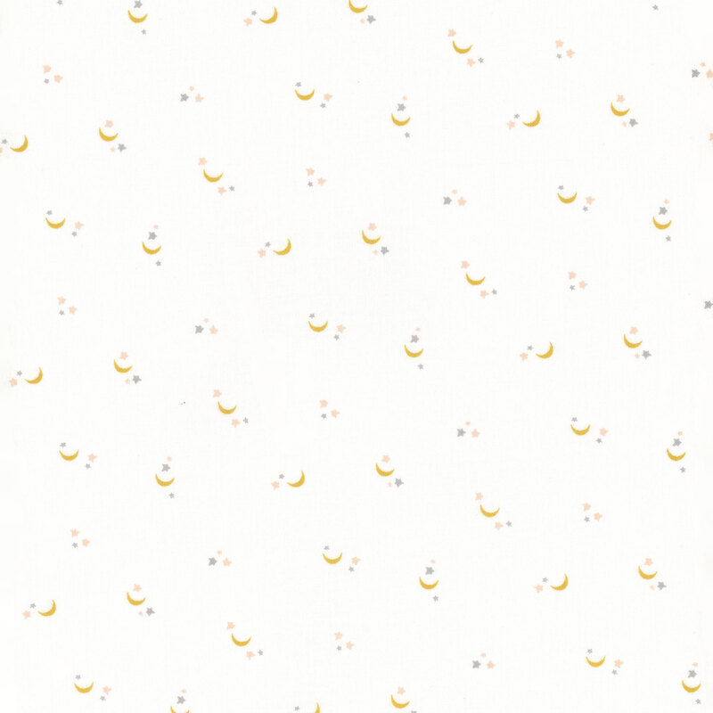 cream cotton fabric with tiny moons and stars scattered all over