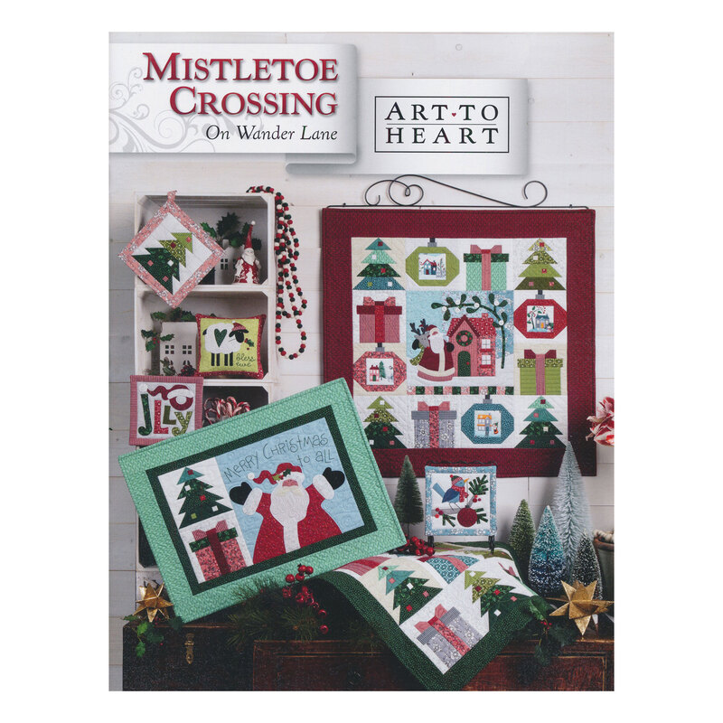 Scan of the front of the Mistletoe Crossing block pattern book, showing the finished quilt and additional finished projects