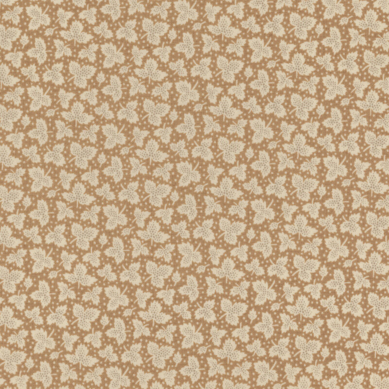 Fabric with light cream tossed leaves and small dots against a light tan background.