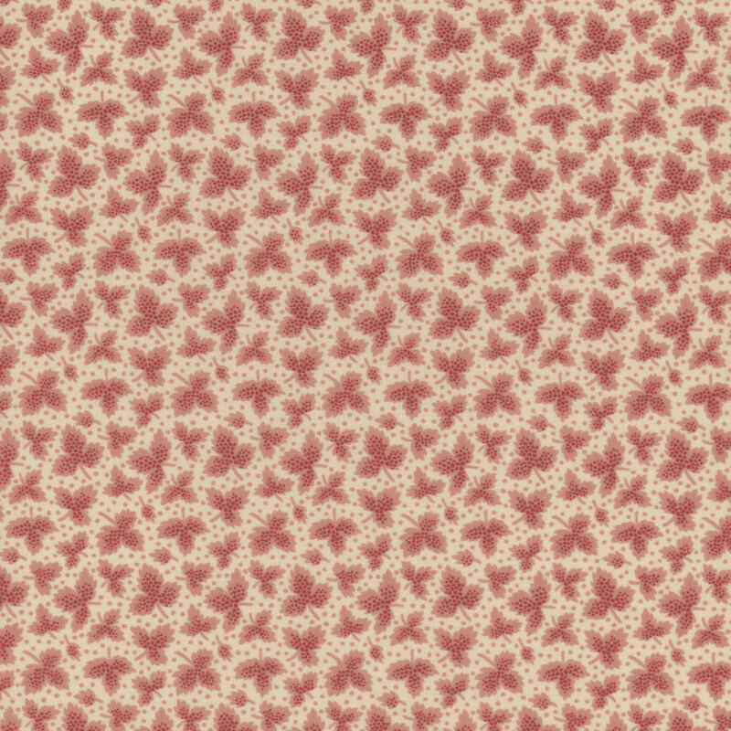 Fabric with light pink tossed leaves and small dots against a cream background.