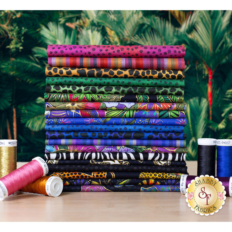 Colorful jungle themed fabrics with gold metallic accents in front of a jungle backdrop