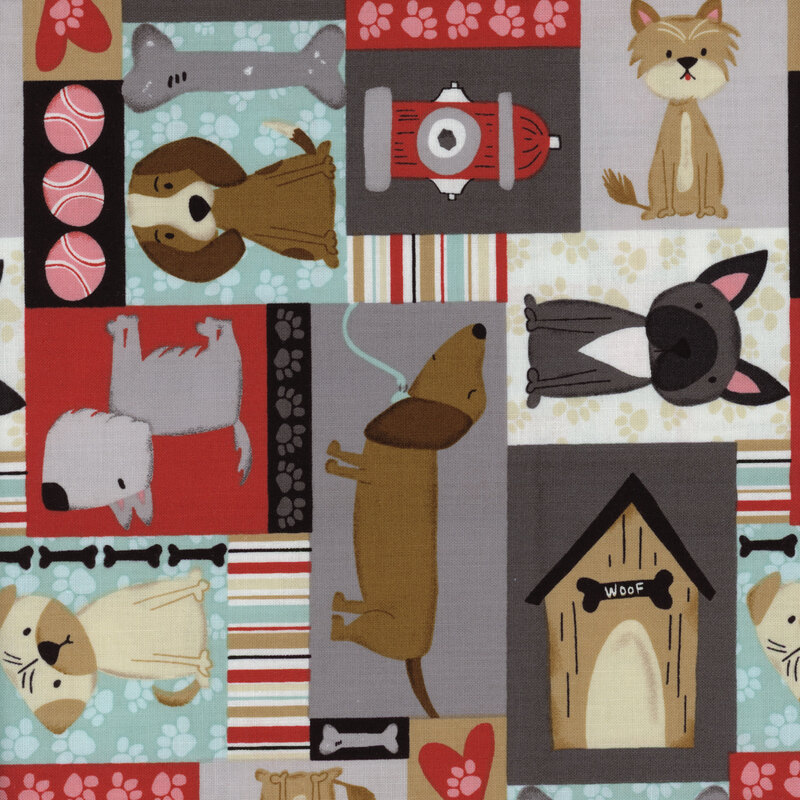 A fabric swatch with different sized squares and rectangles in light blue, grey, and red featuring cartoon dogs, doghouses, bones, fire hydrants, and dog toys