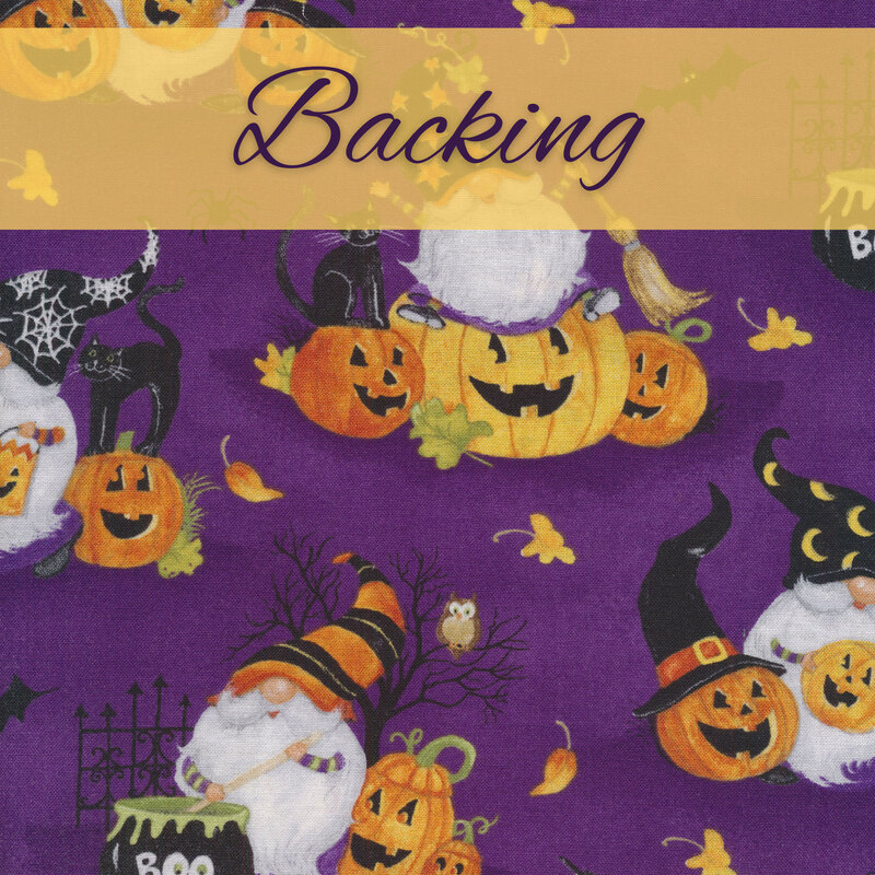 Purple fabric with scenes of witch gnomes, jack-o-lanterns, black cats, and cauldrons with an orange banner and the word 