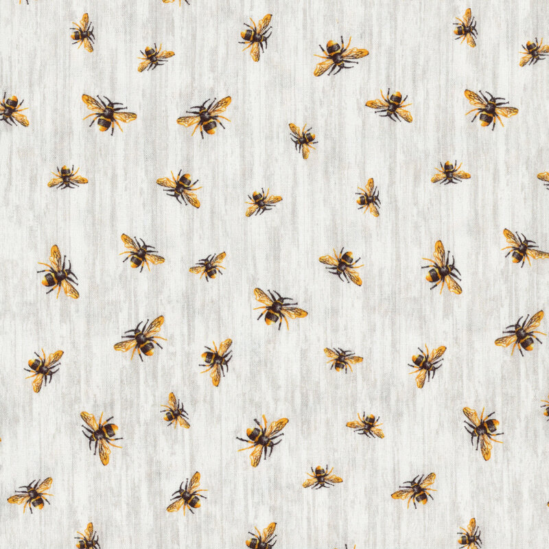 fabric featuring tossed ditsy honey bees on light gray wood grain 