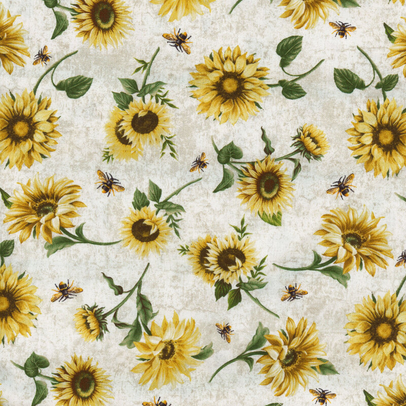 fabric featuring tossed sunflowers with ditsy honey bees on a textured cream and tan background
