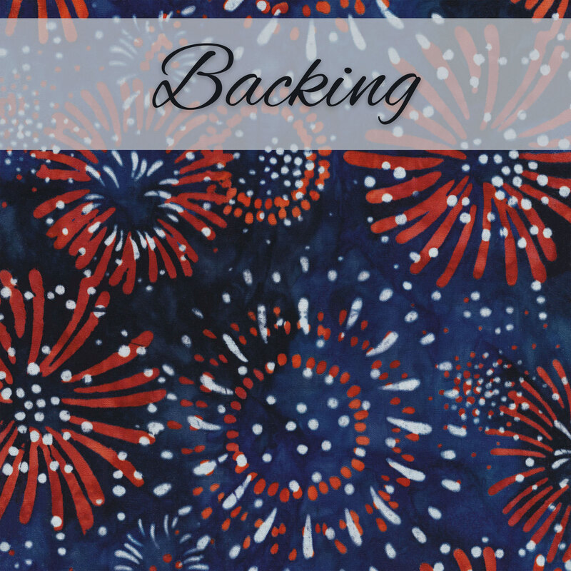 Dark blue batik fabric with red and white fireworks all over and a pale gray banner at the top that reads 