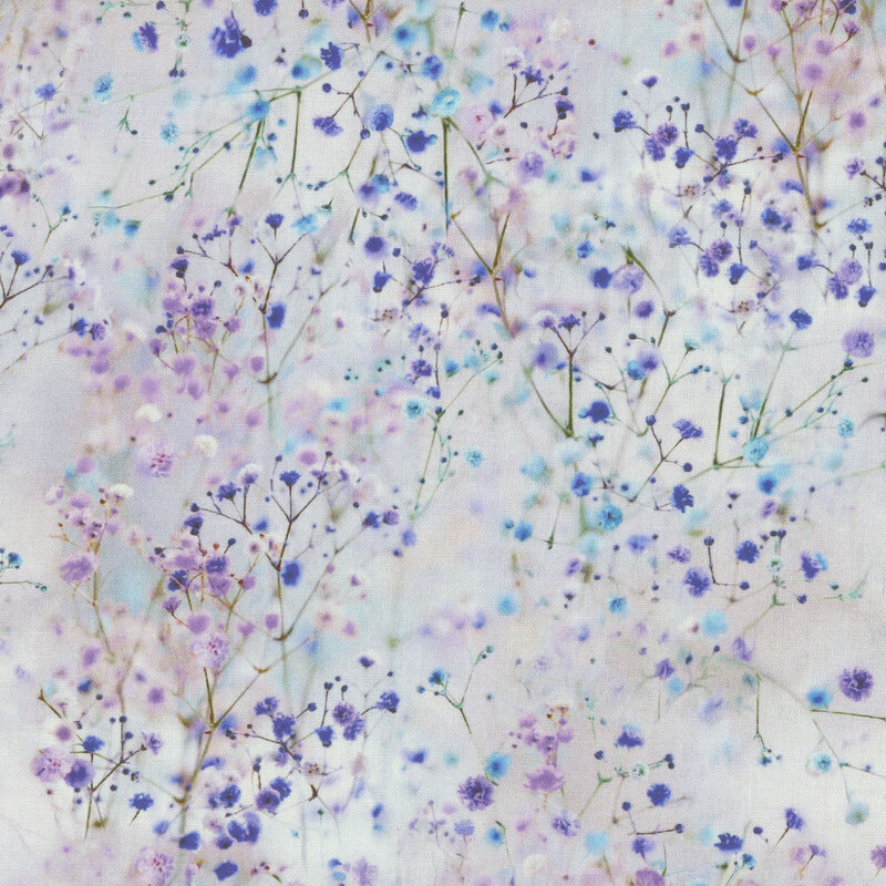 Scan of fabric featuring sprigs of small flowers in shades of blue, purple, and white, set against a foggy gray background