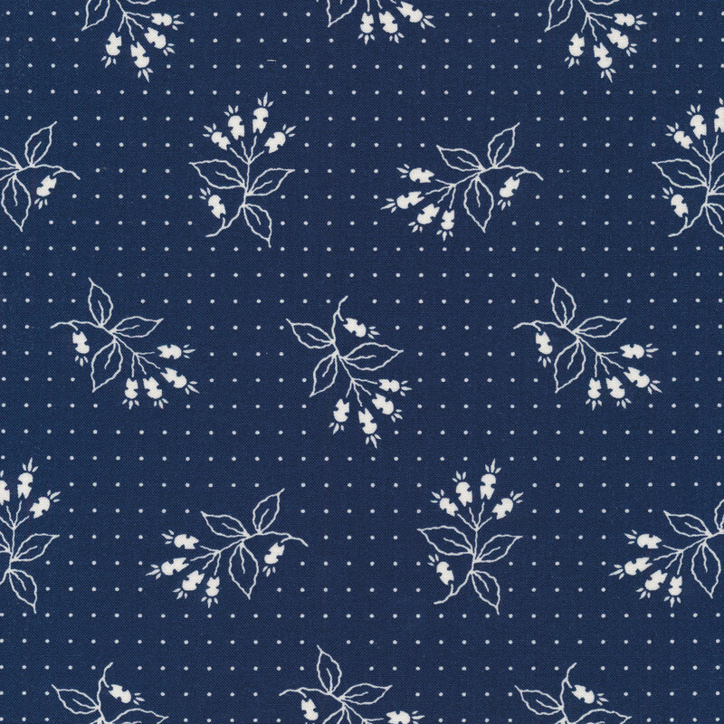 Navy blue fabric with small white dots and tossed white floral motifs 
