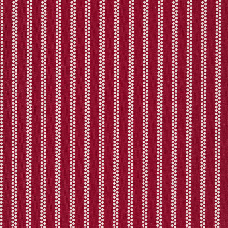 red fabric with white vertical stripes made up of dots