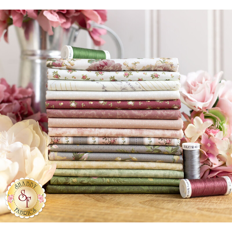 delicate floral fabrics in white, blush, grey, and green, surrounded by flowers on a wood table