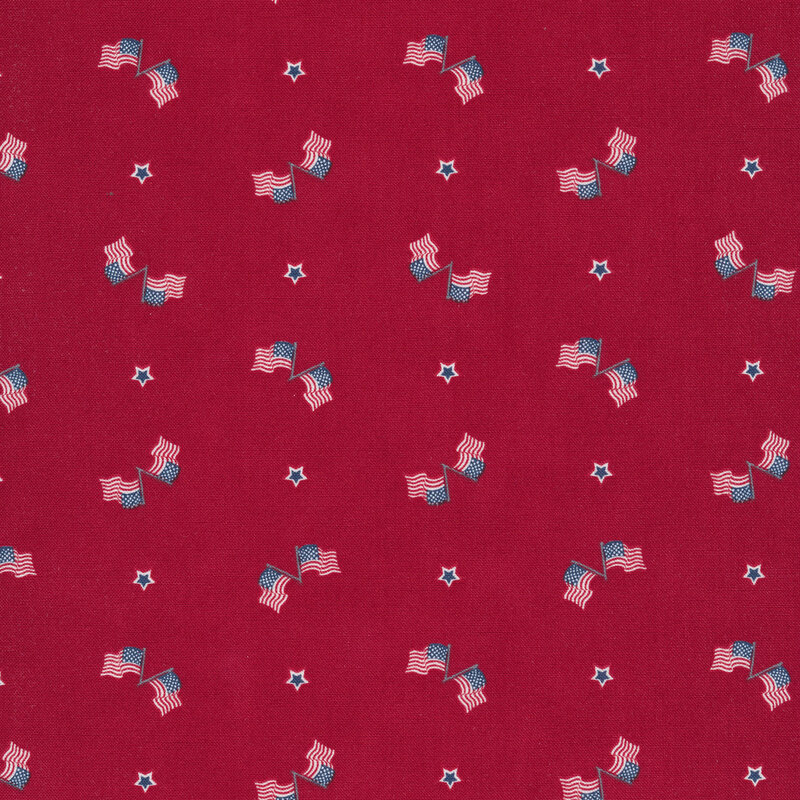 Red fabric with scattered motifs of paired American flags with red, white, and blue stars