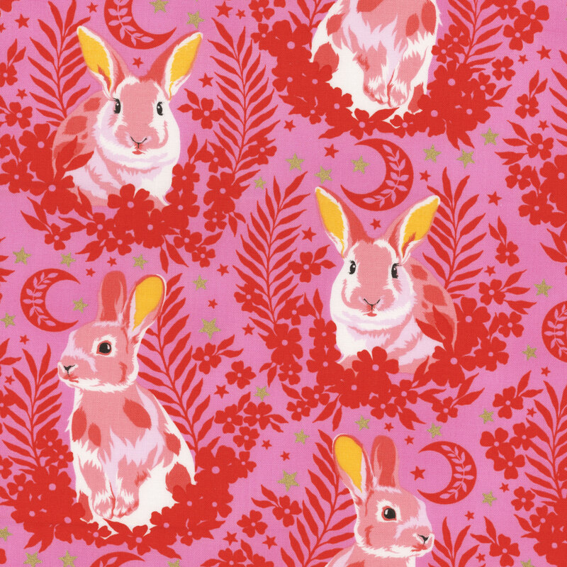 Fabric with light pink bunnies sitting in laurels with stars and crescent moons against a bright pink background