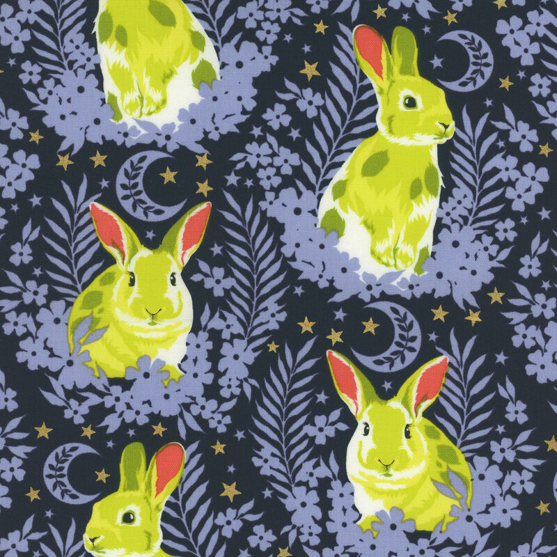 Fabric with neon yellow bunnies sitting in laurels with stars and crescent moons against a deep blue background