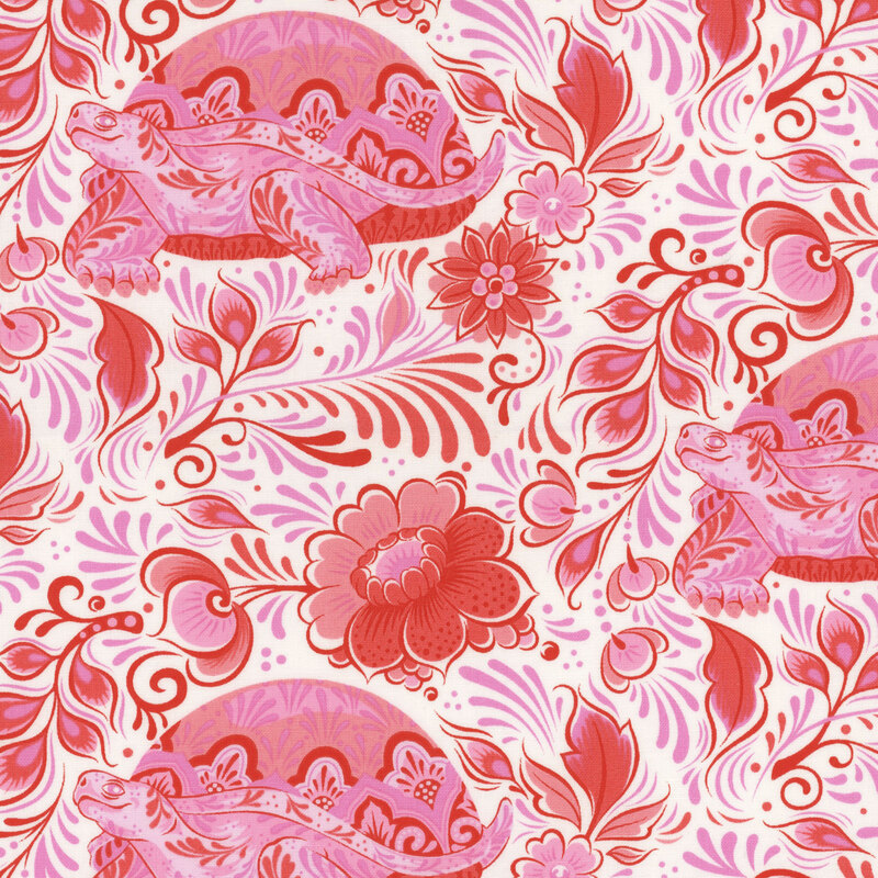 Fabric with pink turtles, florals, and swirling leaves all over a cream background