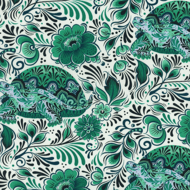 Fabric with teal turtles, florals, and swirling leaves all over a cream background