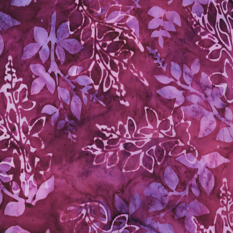 This fabric features layers of mottled purple, blue and pink branches with a dark purple mottled background.