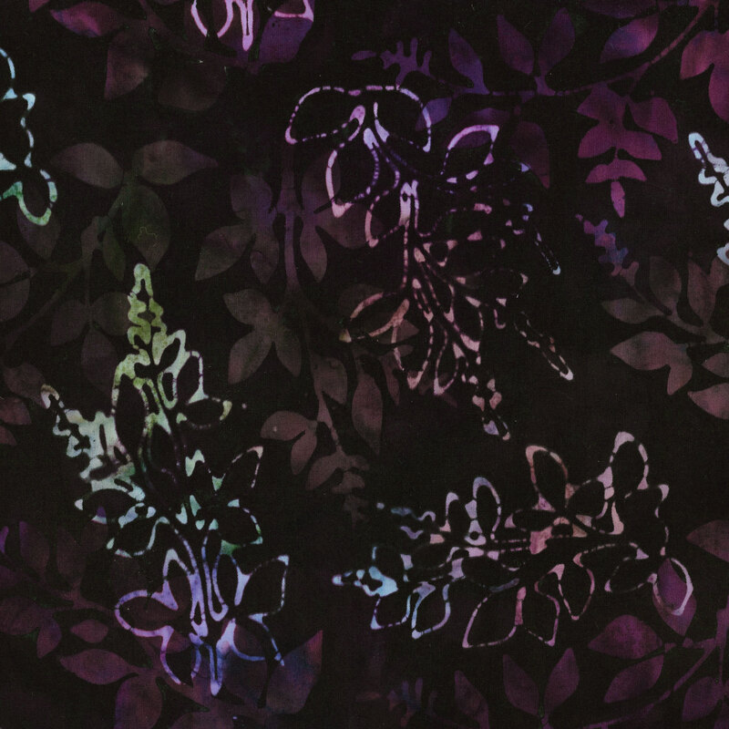 This fabric features layers of mottled green, pink and blue branches with a very dark purple mottled background.