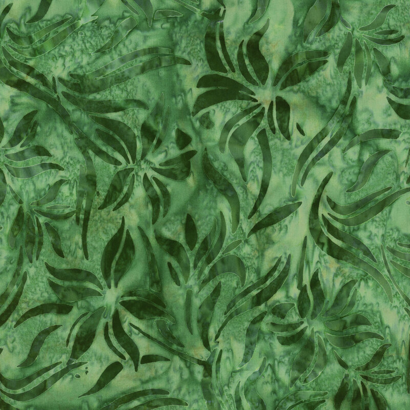This fabric features abstract flowers and leaves in dark green on a mottled green and yellow background.