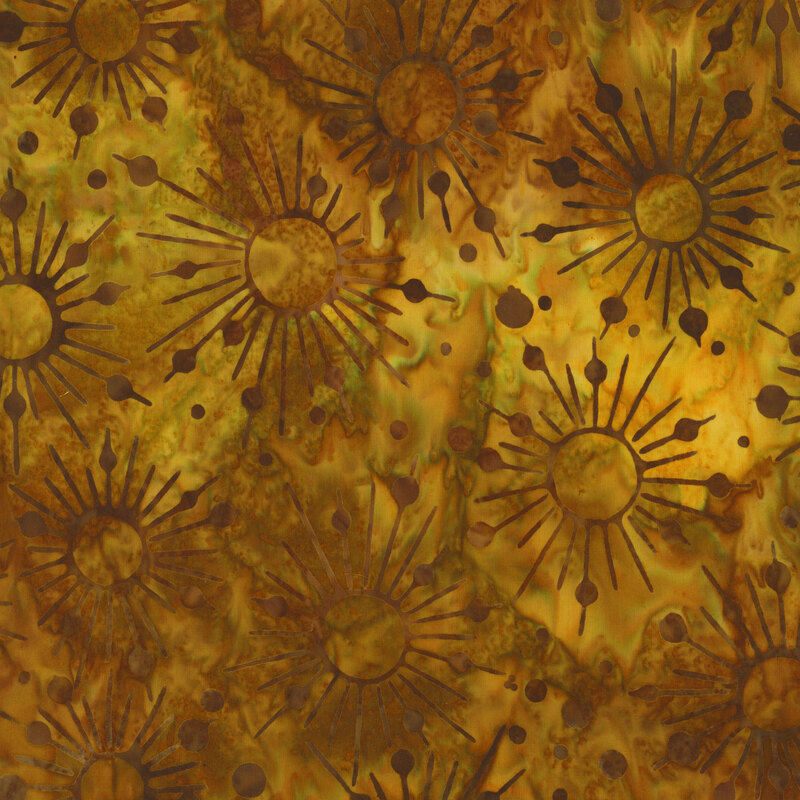 A yellow and brown mottled batik fabric with darker starbursts and dots all over