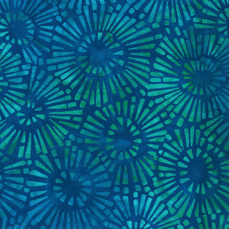 Deep blue mottled fabric with light blue and aqua star bursts