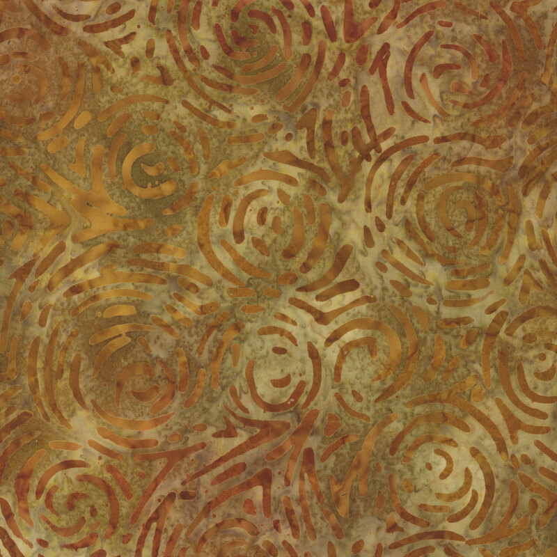 An earth tone golden yellow batik fabric with darker brown and orange broken spirals