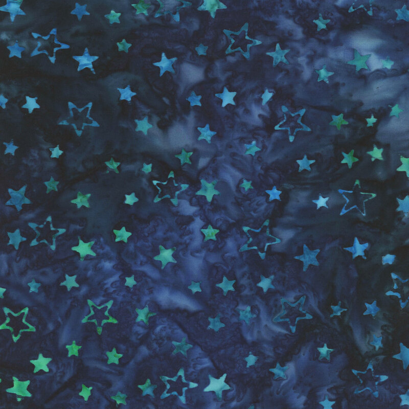 A dark blue mottled batik fabric with light blue and aqua stars all over