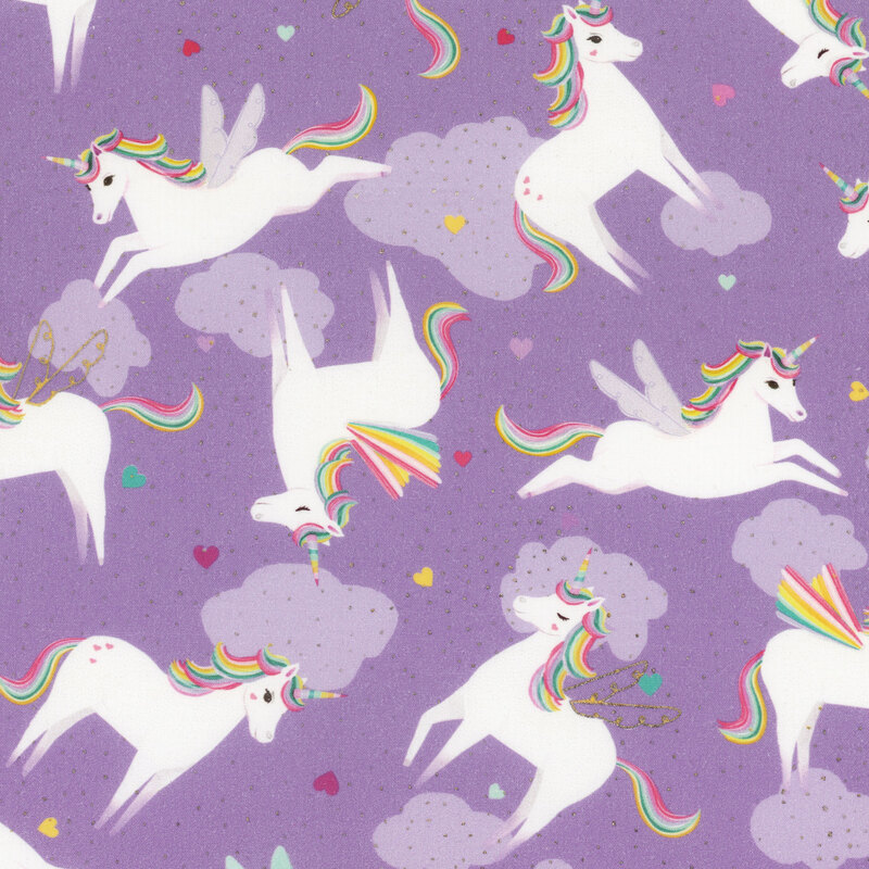 fabric with leaping winged unicorns on a purple background with clouds and tossed multicolored hearts, all with gold accents