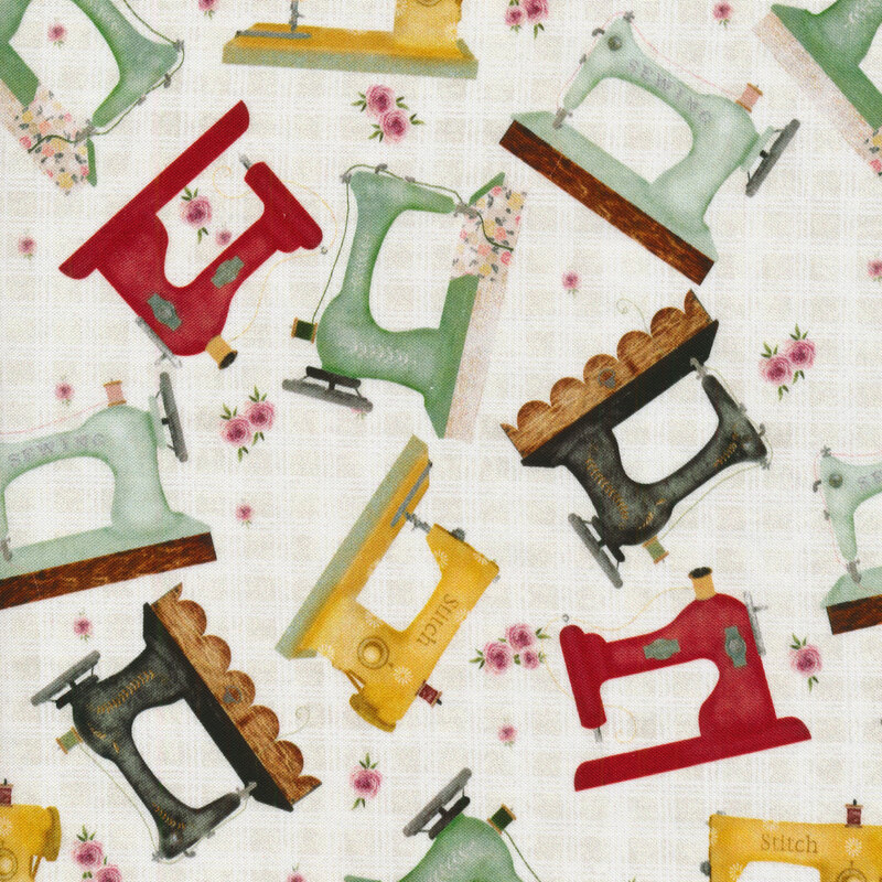 swatch of cream fabric with vintage sewing machines tossed all over