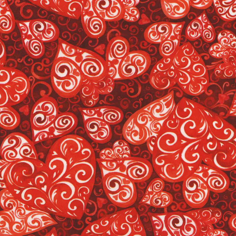 Scan of fabric featuring red hearts composed of swirls in the foreground, set against a red background with tiny tonal hearts and swirls