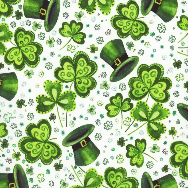 Scan of fabric featuring tossed three-leaf clovers, green top hats, and tiny flowers on a white background