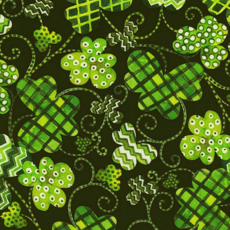 Scan of fabric featuring three-leaf clovers in various sizes and textures such as zigzags, checkers, and dots, connected by dotted swirls and set against a dark green background