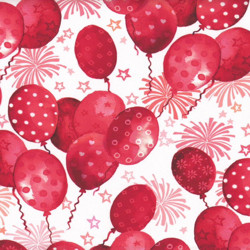 Scan of fabric featuring red balloons with various designs against a white background with stars and fireworks