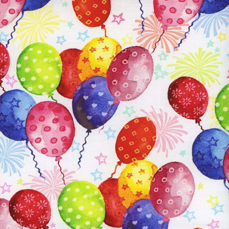 Scan of fabric featuring variously-colored balloons with different patterns on them floating upwards on a white background with small stars and fireworks
