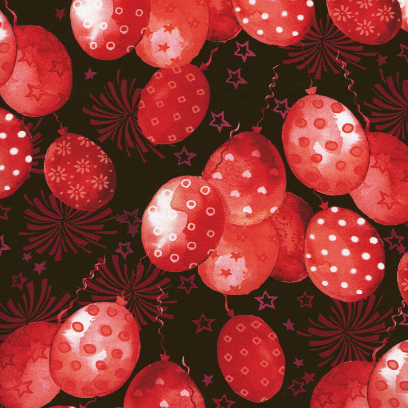 Scan of fabric featuring red balloons with various designs floating upward on a black background with stars and fireworks