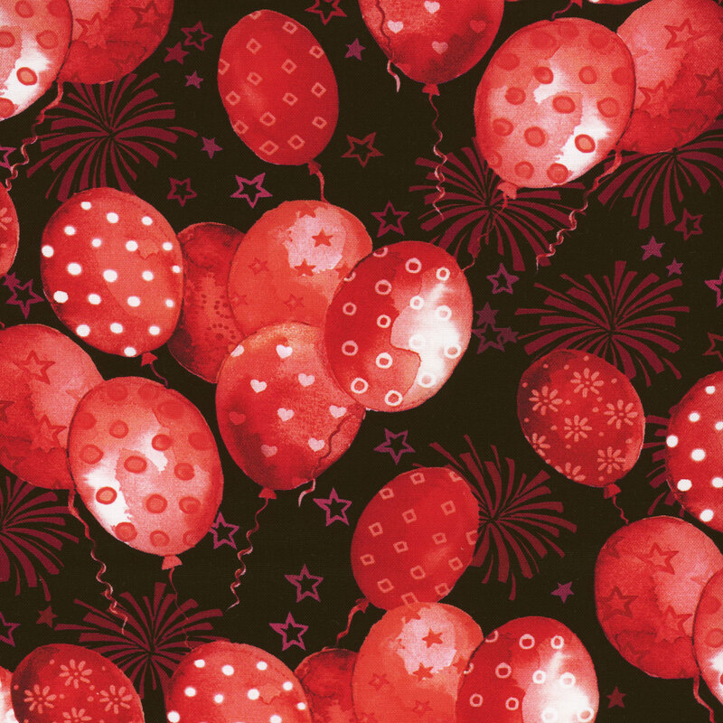 Scan of fabric featuring red balloons with various designs floating upward on a black background with stars and fireworks