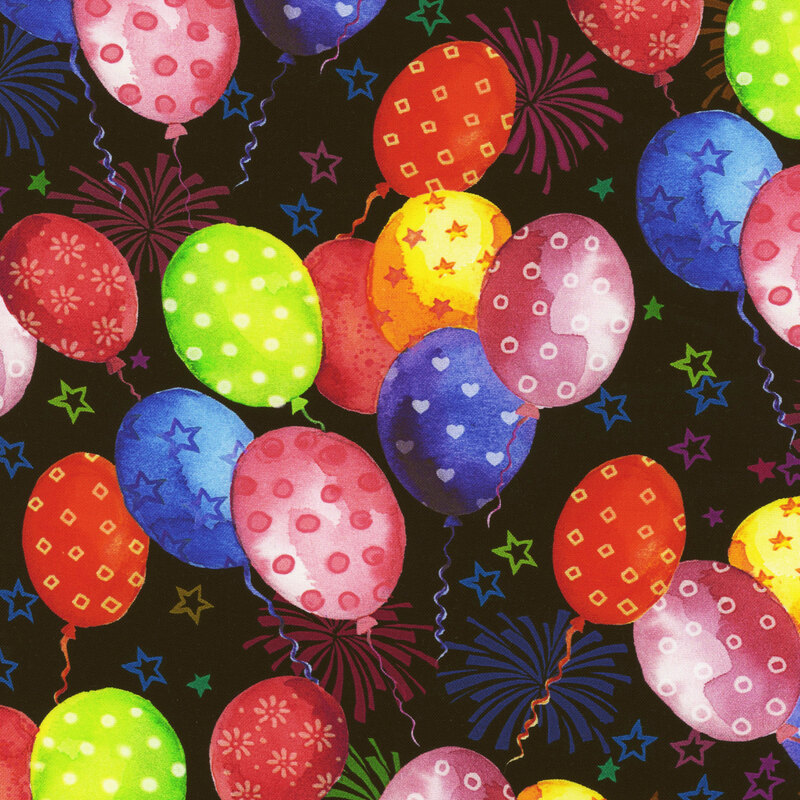 Scan of fabric featuring variously-colored balloons with different patterns on them floating upwards on a black background with small stars and fireworks