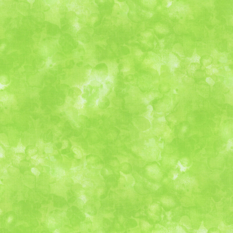 fabric with an apple green color and mottled watercolor markings