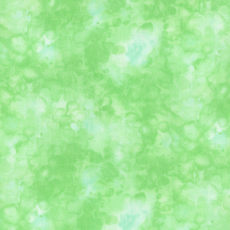 fabric with an light green color and mottled watercolor markings