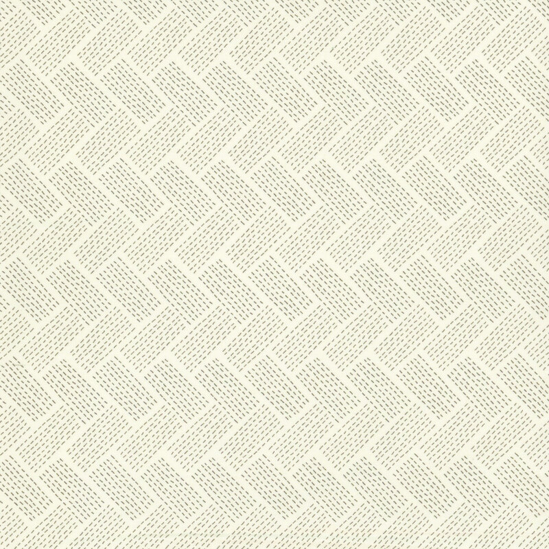 A light cream fabric with a dotted woven chevron pattern