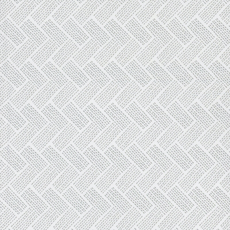 A pale gray khaki fabric with a dotted woven chevron pattern